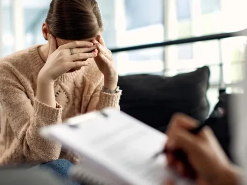 Depressed woman having psychotherapy session at doctor's office