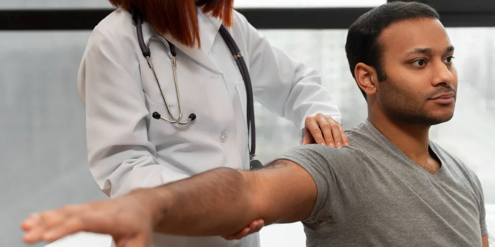 Side view of patient undergoing physical evaluation at physiotherapy clinic