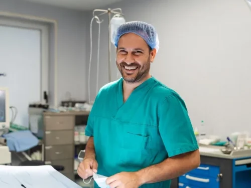 A smiling orthopedic surgeon in operating theater